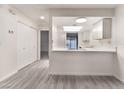 Open-concept living room with kitchen view, and neutral color scheme at 228 N Bruce St # D, Las Vegas, NV 89101