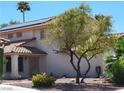 Charming two-story home with mature tree, terracotta roof and solar panels at 2451 Muirfield Ave, Henderson, NV 89074