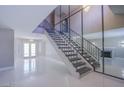 Stunning foyer with grand staircase, modern railings, and gleaming tile floors at 3205 Antilles Ct, Las Vegas, NV 89117