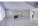 Bright living room with a charming fireplace and expansive tile flooring throughout at 3205 Antilles Ct, Las Vegas, NV 89117