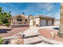Charming single-story home featuring a well-manicured yard and an attached two-car garage at 3665 S Pointe Cir, Laughlin, NV 89029