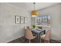 Dining room features modern light fixture and a four-chair dining set at 4730 E Craig Rd # 1172, Las Vegas, NV 89115