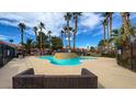 Relaxing community pool area surrounded by palm trees and comfortable seating at 4730 E Craig Rd # 1172, Las Vegas, NV 89115