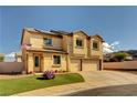 Two-story stucco home featuring a two-car garage and well-maintained lawn on a clear day at 58 Desert Castle Ct, Henderson, NV 89012