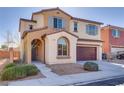 Two-story home with desert landscaping featuring a two-car garage, arched entryway, and gray shutters at 7203 Pepperbox Ave, Las Vegas, NV 89179