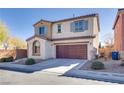 Front exterior of a two-story home showcasing neutral paint, shuttered windows, and a two-car garage at 7203 Pepperbox Ave, Las Vegas, NV 89179