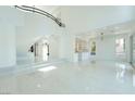 Expansive open-concept space with grand staircase and marble floors, perfect for modern living at 8208 Horseshoe Bend Ln, Las Vegas, NV 89113