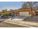 Single-story home featuring a two-car garage, desert landscaping, and a neutral color scheme at 10013 Arbuckle Dr, Las Vegas, NV 89134