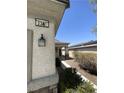 Close-up view of the house number and exterior wall with a decorative lantern at 2341 Celestial Moon St, Henderson, NV 89044
