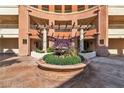 A beautifully landscaped courtyard entrance with lush plantings and decorative water feature at 260 E Flamingo Rd # 113, Las Vegas, NV 89169