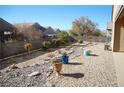 View of the backyard landscaping that features desert rocks, plants, and fencing at 2601 Centaurus St, Henderson, NV 89044