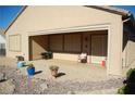 A covered patio with a chair, table, and some potted plants at 2601 Centaurus St, Henderson, NV 89044