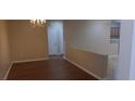 A dining room with a chandelier and hardwood flooring, perfect for Gathering meals at 2601 Centaurus St, Henderson, NV 89044