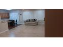 Spacious living room featuring tile flooring, shutters, and a comfortable sofa at 2601 Centaurus St, Henderson, NV 89044