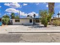 Charming single-story home featuring a xeriscaped front yard, mature shade trees, and a large driveway at 2716 Salt Lake St, North Las Vegas, NV 89030