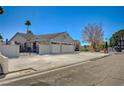 Wide driveway leading to a two-car garage on a well-maintained property with secure gated entry at 3181 Shadow Bluff Ave, Las Vegas, NV 89120