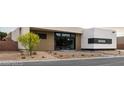 A one-story home with desert landscaping, a black trimmed glass front door, and grey driveway at 3430 Cosima Ln, Las Vegas, NV 89120