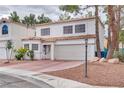 Charming two-story home featuring a neutral stucco facade, red tile roof, meticulously maintained front yard with an attached two-car garage at 3491 Bankside Dr, Las Vegas, NV 89129