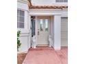 Elegant front entrance featuring a decorative glass door flanked by charming decorative cat statues and lush landscaping at 3491 Bankside Dr, Las Vegas, NV 89129