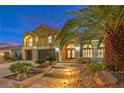 Beautiful two-story home with desert landscaping and lush palm trees lining the front walkway and entryway at 4045 Abernethy Forest Pl, Las Vegas, NV 89141