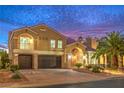 Beautiful two-story home with desert landscaping, three-car garage, and an inviting arched entryway at 4045 Abernethy Forest Pl, Las Vegas, NV 89141