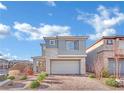 Charming home featuring a brick driveway, desert landscaping, and a modern two-car garage at 409 Wind Poppy St, Las Vegas, NV 89138