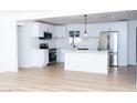Bright, modern kitchen with white cabinetry, stainless steel appliances, and a center island at 4818 E Monroe Ave, Las Vegas, NV 89110