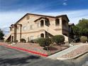 Multi-story condo building with desert landscaping and stucco exterior at 5751 E Hacienda Ave # 130, Las Vegas, NV 89122