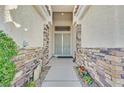 Inviting entryway with stone accents and a secure, decorative screen door at 6710 Pyracantha Glen Ct, Las Vegas, NV 89131