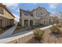 Attractive exterior view of home featuring manicured landscaping and community sidewalks at 73 Lomita Heights Dr, Las Vegas, NV 89138