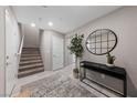 Foyer with stylish decor, a staircase, and neutral-colored walls at 73 Lomita Heights Dr, Las Vegas, NV 89138