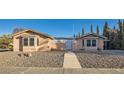 Inviting single-story home with a decorative gate, desert landscaping, and a charming facade at 798 Shirley Ln, Boulder City, NV 89005