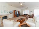 Bright living room with a fireplace, neutral carpet, and lots of seating at 814 Lake Hill Dr, Boulder City, NV 89005