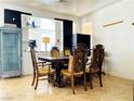 Dining room featuring a table with decorative wood chairs and tile flooring at 8209 Violet Meadow Ct, Las Vegas, NV 89117