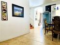 Inviting entryway featuring tile flooring and decorative wall art, leading to the dining area at 8209 Violet Meadow Ct, Las Vegas, NV 89117