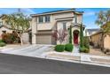Inviting exterior view of a home with a red front door and freshly landscaped front yard at 9138 Sea Mink Ave, Las Vegas, NV 89149