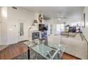 Spacious living room featuring a fireplace, hardwood floors, and a sliding glass door at 1545 Peaceful Pine St, Henderson, NV 89052