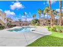 Inviting community pool surrounded by lush landscaping and palm trees at 1810 N Decatur Blvd # 201, Las Vegas, NV 89108