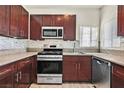 Updated kitchen features stainless steel appliances, granite counters, tile backsplash and modern fixtures at 1830 N Buffalo Dr # 2106, Las Vegas, NV 89128