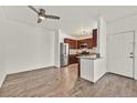 Open floor plan with updated flooring offers a seamless transition from kitchen to living space at 1830 N Buffalo Dr # 2106, Las Vegas, NV 89128