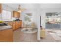 Eat-in kitchen with wood cabinets, tile floors, and view of the sliding glass doors to the backyard at 2229 La Puente St, Las Vegas, NV 89115
