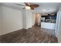 Bright living area featuring wood-look floors, white walls, and seamless flow to the modern kitchen at 2734 Champagne Gold Ave, North Las Vegas, NV 89086