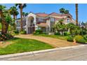 Beautiful two-story home featuring a well-manicured lawn, mature palm trees, and a circular driveway at 3341 Camino Gardens Way, Las Vegas, NV 89146