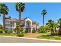 Beautiful two-story home featuring a well-manicured lawn, mature palm trees, and a circular driveway at 3341 Camino Gardens Way, Las Vegas, NV 89146
