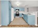 Charming kitchen features custom blue cabinetry and modern appliances at 3425 E Russell Rd # 114, Las Vegas, NV 89120