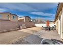 Spacious backyard featuring patio with pavers and a built-in grill at 3934 Jamison Park Ln, North Las Vegas, NV 89032