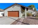 A lovely single-story home featuring a red garage door and low-maintenance landscaping at 4768 W Montara Cir, Las Vegas, NV 89121