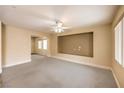 Open living room featuring neutral walls, carpet, a ceiling fan and a niche for a TV at 4787 Essen Ct, Las Vegas, NV 89147