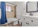 Bright bathroom features a tub and shower combination with a white vanity and sink at 5168 Wilbur St, Las Vegas, NV 89119