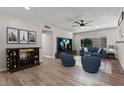 Bright living room with hardwood floors, modern furnishings, and a large flat screen television at 5168 Wilbur St, Las Vegas, NV 89119